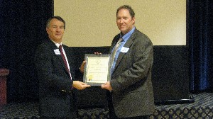 In January, Rod Pohlmann (l), chapter vice president, presents Jeff Devine with an AFCEA Lifetime Membership.